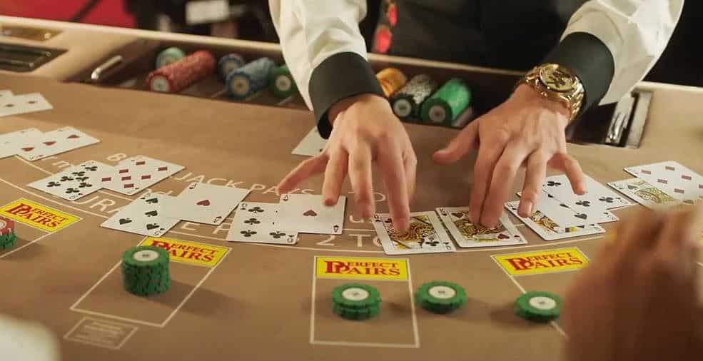 blackjack dealer dealing cards at the table.